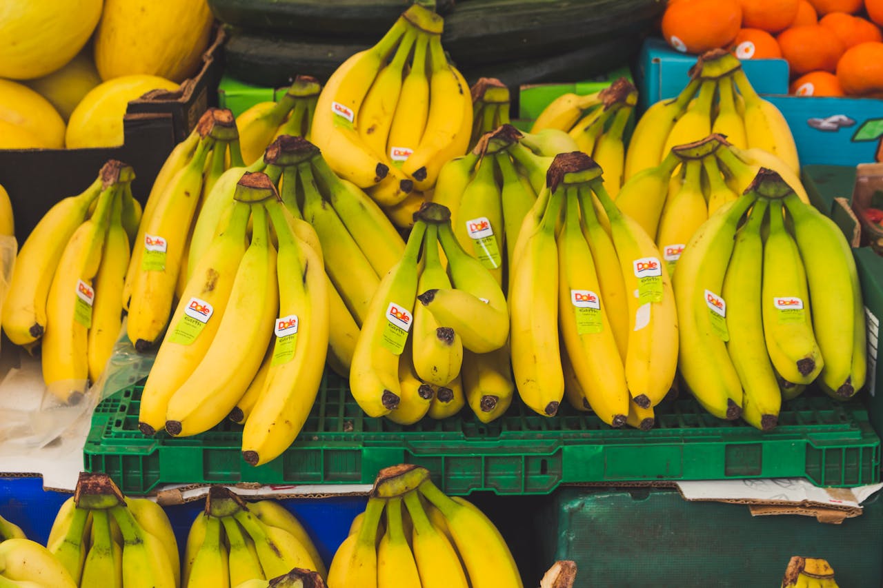 gallery-01 A vibrant display of fresh bananas at a local market stand, perfect for healthy eating.